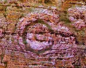 Image of a patch of rock about 14 by 17 miles in size in the middle of the Sahara Desert.  This image links to another image. 